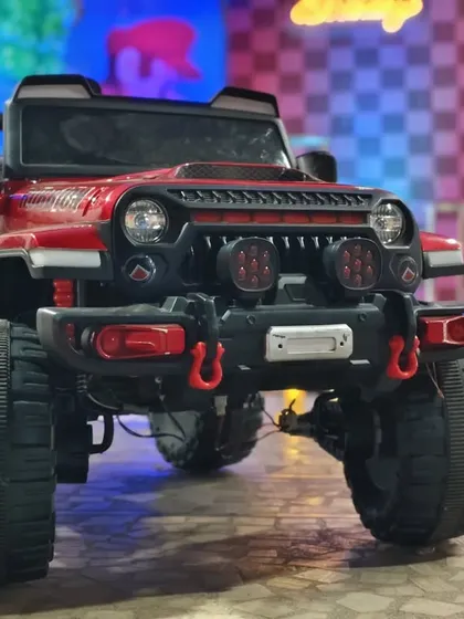 A close-up of the red toy jeep used for a grand entrance at a Super Mario themed party.