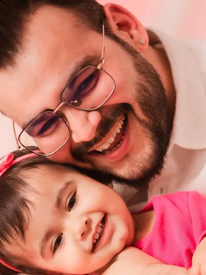 A father and daughter sharing a sweet cuddle. This close-up is full of warmth and love.