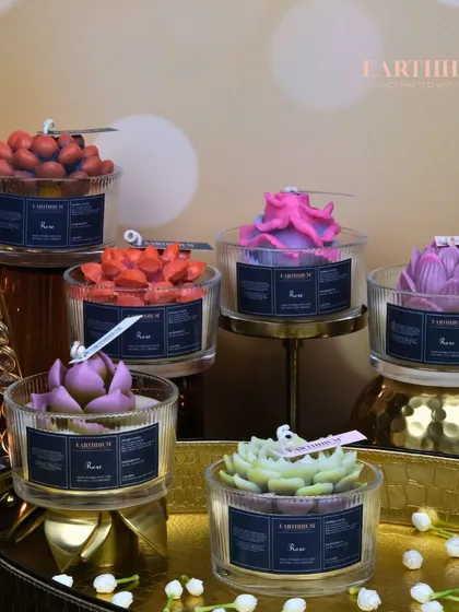 A full display of my floral votives in ribbed glass jars, showcasing the variety of flower types and colors available, from succulents to roses.
