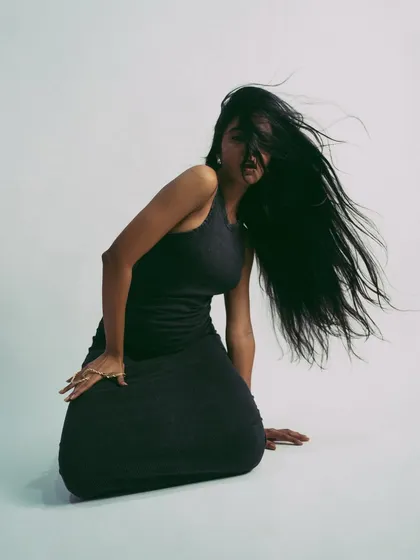 A studio shot focused on movement, with the model's long hair creating beautiful shapes. This demonstrates a model's ability to work with motion.