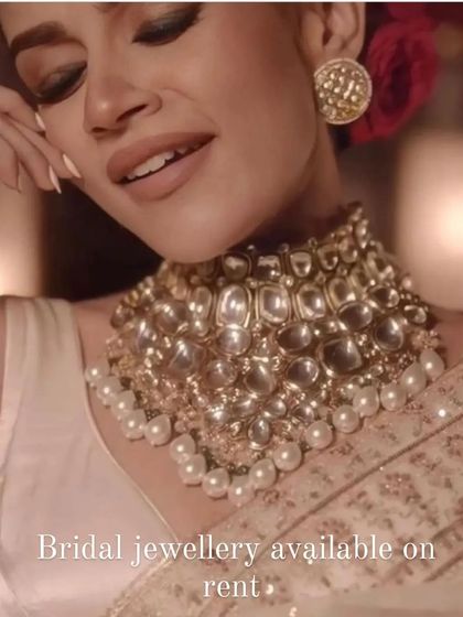 A model wearing a heavy uncut kundan choker with pearl drops. This piece is available for rent and is perfect for a reception or engagement look.