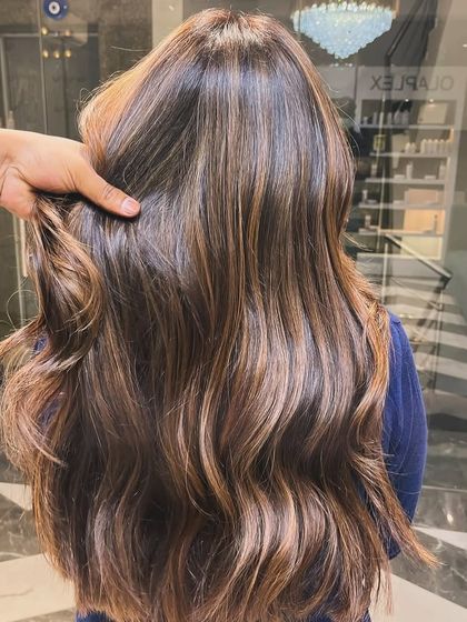 Soft, natural-looking highlights that blend seamlessly with the base color. This is a great example of a low-maintenance yet impactful hair color update.