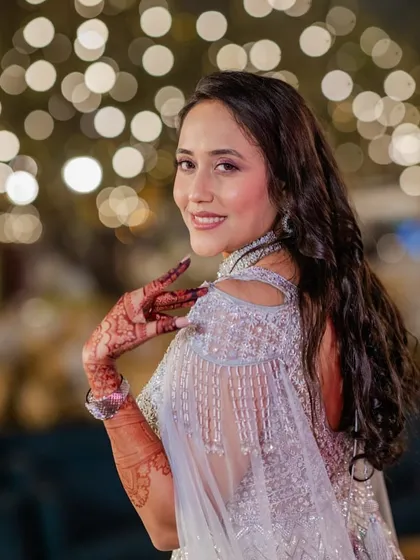 A playful and happy shot of the reception bride. The makeup is designed to look flawless and radiant, capturing her joyful spirit.