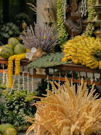 An arrangement of auspicious items, including fresh coconuts, bananas, and lavender. These elements are not just decorative but are integral to the rituals of a South Indian wedding ceremony.