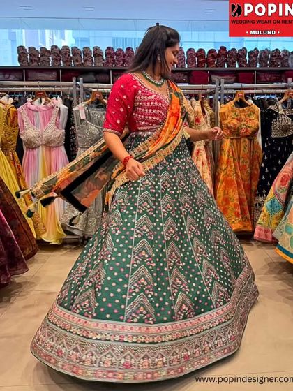 A dynamic shot of the green printed lehenga, capturing the movement of the skirt. The combination of green, pink, and a multi-color dupatta is simply stunning.