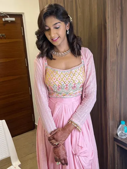 Vaishnavi looking elegant in her pink outfit. The soft curls and minimal makeup are perfect for a chic, understated look.