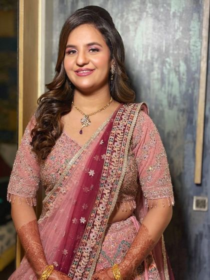 Another angle of the beautiful pink engagement look. The soft curls and subtle makeup create a timeless and romantic vibe.