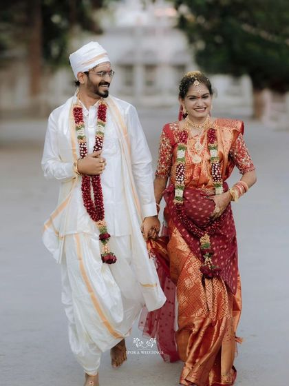 The couple walking together, the groom holding the bride's hand and guiding her, a symbol of their new journey.