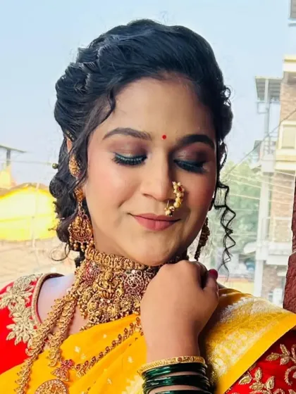 A detailed close-up of the bride's face, showing the soft eye makeup and the traditional `nath`.