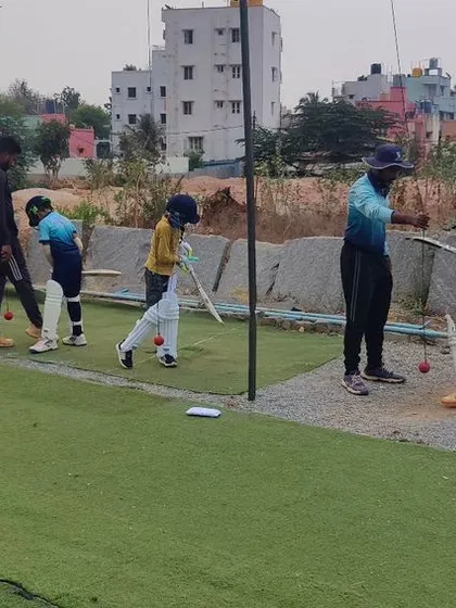 A snapshot from our summer camp, with players practicing their batting in the nets.