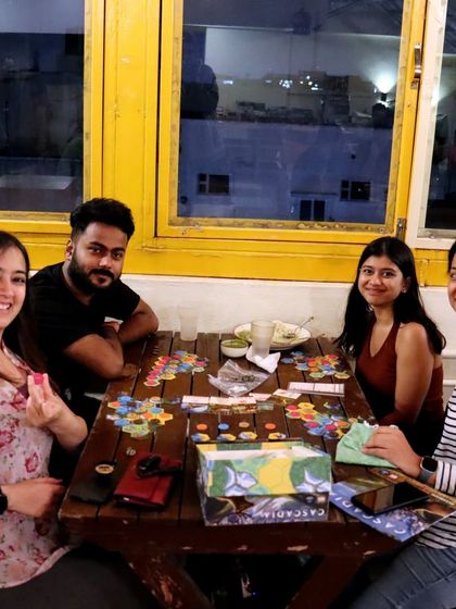 A game of Cascadia in progress by the window. The natural light and relaxed atmosphere make it a great spot for an afternoon of strategic tile-laying and fun.