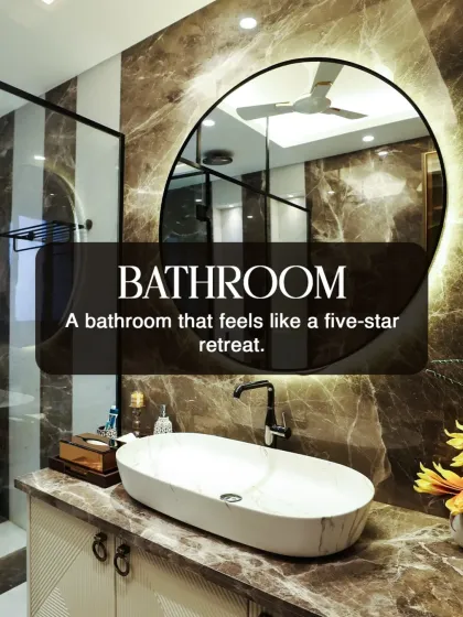 We design bathrooms that feel like a five star retreat. This space features dramatic brown marble, a backlit mirror, and a sleek vessel sink for a truly high end experience.