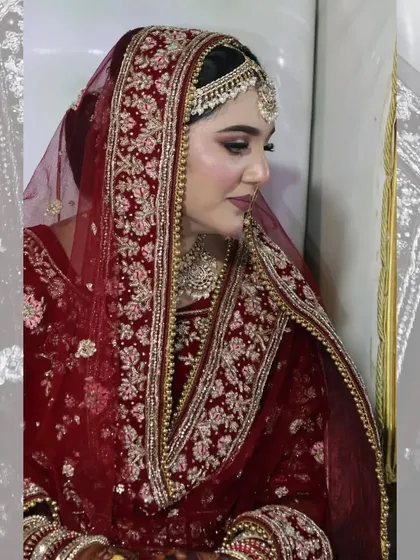 An elegant solo portrait of a bride, showcasing her intricate wedding attire and makeup.