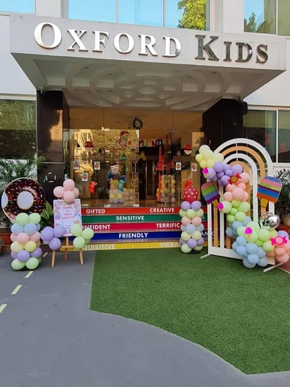 The entrance to a sweet Candyland-themed party, decorated with pastel balloons and a donut cutout.