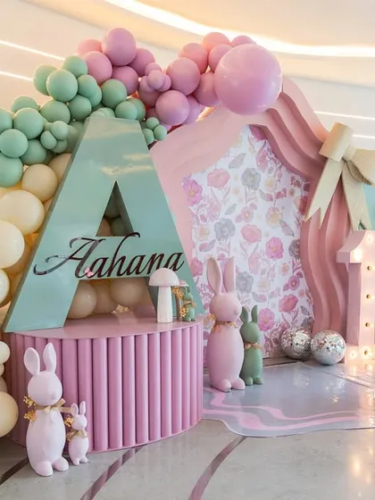 A side view of the "Onderland" backdrop, highlighting the layered construction, the large initial "A" for Aahana, and the adorable bunny and mushroom props.