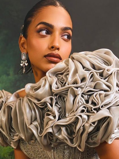 A detail shot of the Bellerose Gown's 3D cape, where each petal is crafted to create a blooming rose effect, adding a layer of sublime, sculptural art.