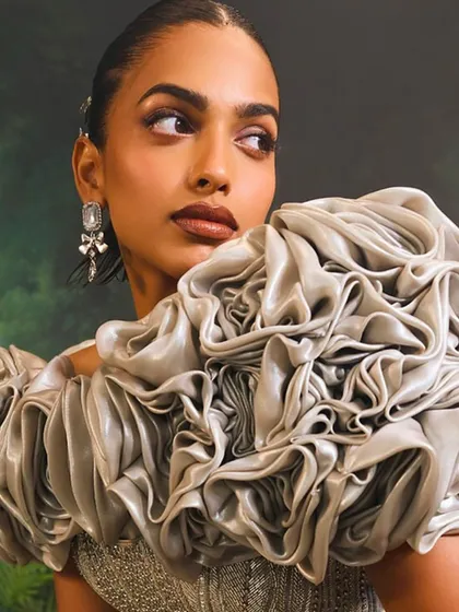 A detail shot of the Bellerose Gown's 3D cape, where each petal is crafted to create a blooming rose effect, adding a layer of sublime, sculptural art.