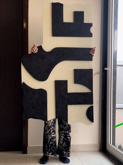 I had some fun with this one, my pants almost match the painting! This is a large, irregularly shaped piece with bold, black textured forms on a cream background, created for a modern home in Mumbai.