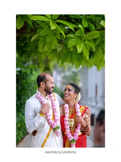 A classic portrait of the bride and groom, smiling at each other. We capture the love and happiness of the couple with natural posing under a canopy of green leaves.