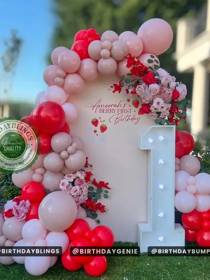 We create adorable and memorable first birthday celebrations, like this "Berry First Birthday" theme. Set outdoors, this design features a custom arch backdrop, a beautiful balloon garland in shades of red and pink, and a light-up number '1' for the perfect finishing touch.