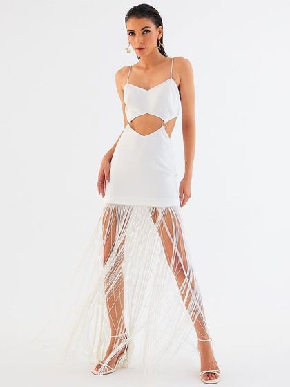 A full-length shot of a white fringe dress for Tisharth by Shivani. The clean, minimalist look was achieved on our white cyclorama, allowing the garment's texture and movement to be the main focus.