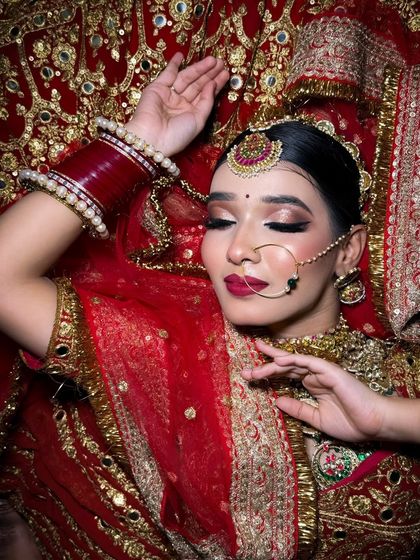 A graceful pose showing the bride's elegant makeup and hairstyle. The closed eyes highlight the beautiful blend of her eyeshadow.