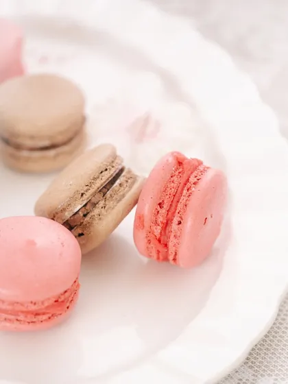 A clean and simple composition of macarons on a white plate, demonstrating the power of minimalist styling.