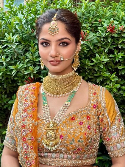 This look is all about modern elegance with a classic soul. The rust-orange lehenga paired with soft glam makeup is a perfect choice for the contemporary bride.
