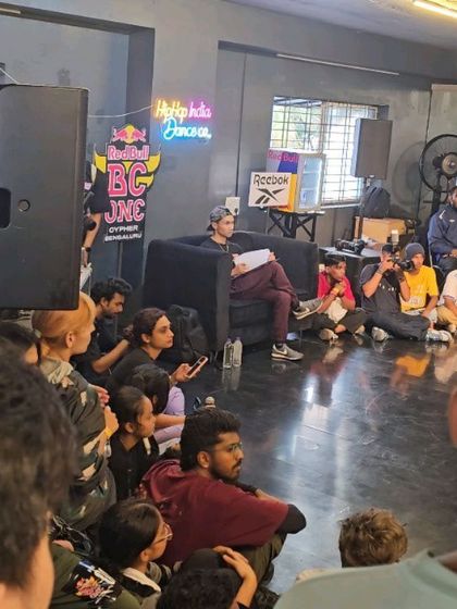 It's not just about battling, it's about learning. Here, dancers listen intently during a session at the Red Bull BC One qualifier, absorbing knowledge from the judges and mentors.
