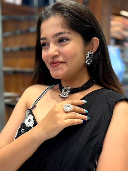 The matching earrings and statement ring complete this stylish party look.