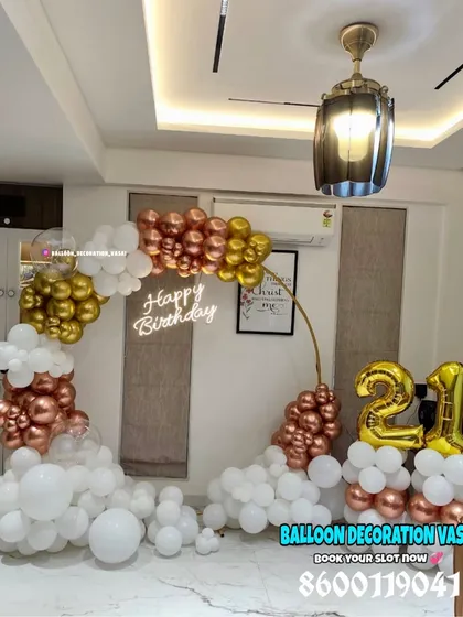 Celebrating a 21st birthday with a touch of class. This elegant ring backdrop is decorated with a cascade of rose gold, gold, and white balloons, complete with a "Happy Birthday" neon sign for a modern look.