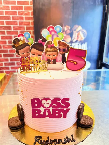 A pink Boss Baby cake for a girl's 5th birthday, featuring the female characters from the series.