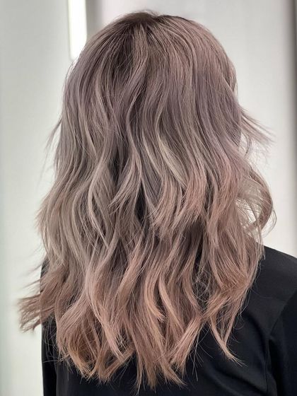 A beautiful, multi-tonal blonde with hints of rose and ash. This look is soft, dreamy, and perfect for someone wanting a unique twist on blonde.