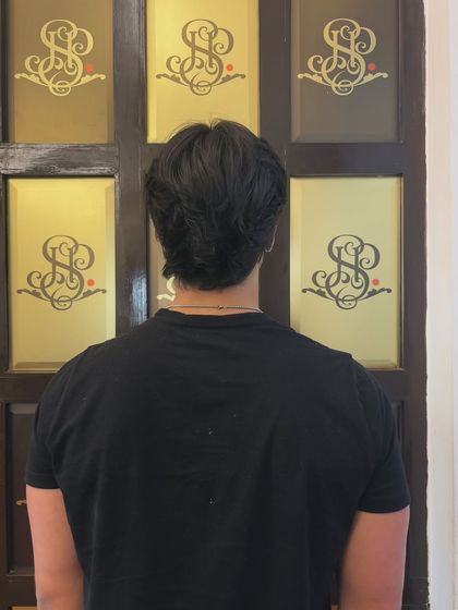 The back view of the men's cut, highlighting the expert layering and texturizing that goes into creating a polished look.