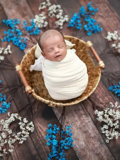 A tiny miracle. This overhead shot shows how perfectly this baby is swaddled in a basket, looking like a precious gift.