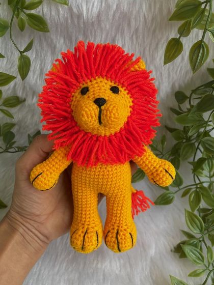 A vibrant version of the Lion King, Simba! This one has a bright yellow body and a fiery orange mane, making him look just like the character from the movie.