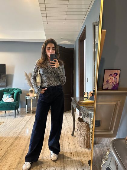 A casual fall outfit featuring an animal print sweater and corduroy pants. A great example of mixing textures.