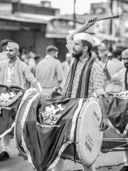 The black and white version of the dhol player in the white cap.