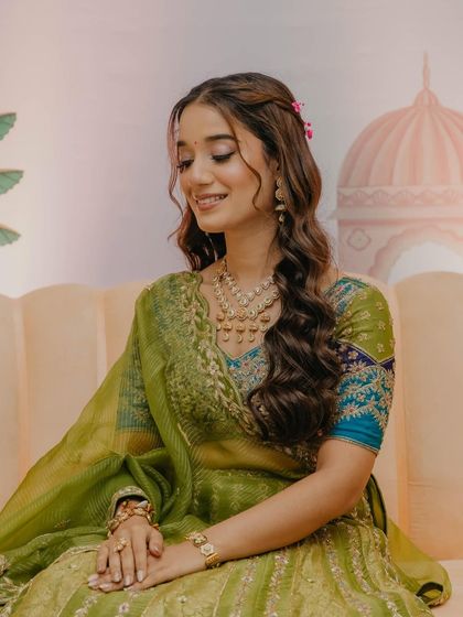 A sweet, candid moment. The soft waves with floral details and the glowing makeup create such a romantic and fresh look.