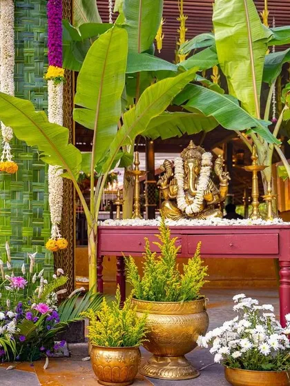 A traditional Ganesha setup to welcome guests and bring blessings to the wedding, framed by banana trees and floral arrangements.