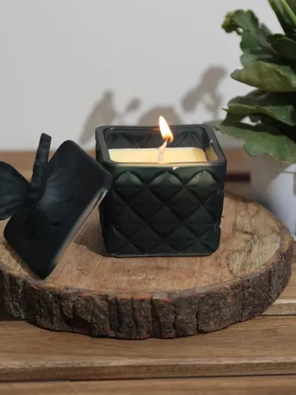 Our black quilted candle with a butterfly-adorned lid. This chic and minimal piece adds a touch of sophisticated drama to any space, perfect for a modern home.