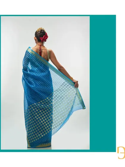 The back of the Persian blue saree reveals the beautiful contrast of the checkered pattern against the sheer organza fabric.