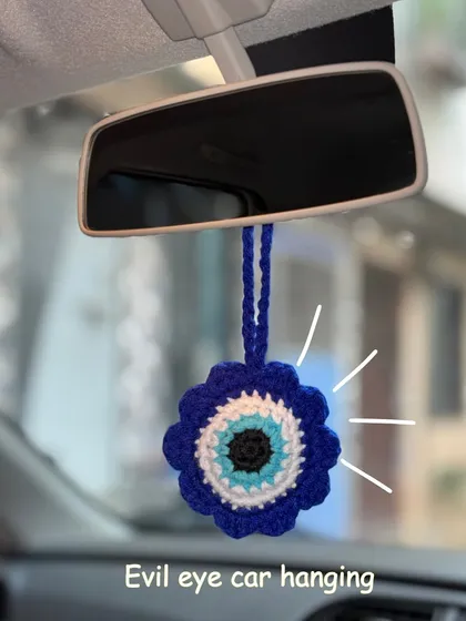 Keep the bad vibes away with this crochet evil eye car hanging. It's a trendy and handmade accessory to add a bit of personality and protection to your ride.