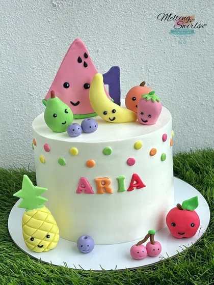 The full view of the adorable fruits-themed cake.