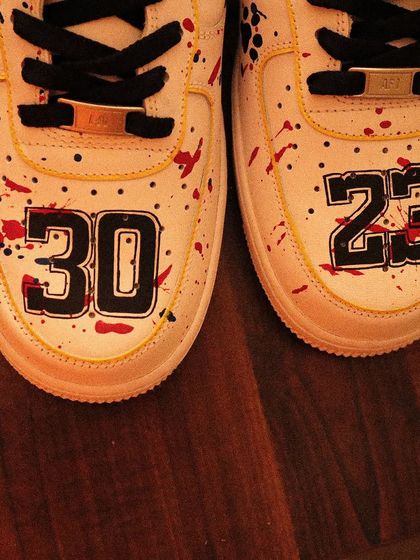 A basketball-inspired design with a twist. I painted these Nike Air Force 1s with a red and blue paint splatter effect, custom jersey numbers on the toe box, and a swoosh that looks like a basketball.