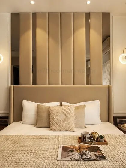 A master bedroom should be a serene retreat. For this contemporary bedroom, I used warm neutrals, plush textures, and elegant lighting to create an inviting ambiance. The tall, upholstered headboard with vertical paneling serves as a sophisticated focal point.