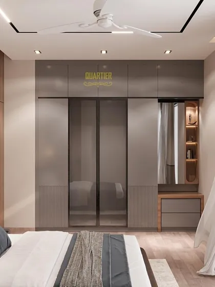 A view of the wardrobe in the Cleo County master bedroom render. The design includes smoked glass doors and an integrated dressing unit, combining sleek style with practical functionality.