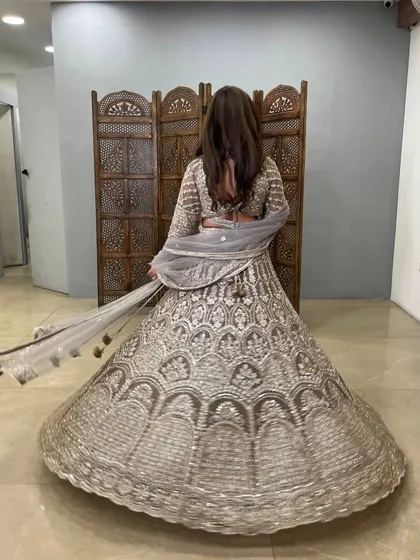 The back view of this grey lehenga, showing off the full flare and the beautiful twirl.