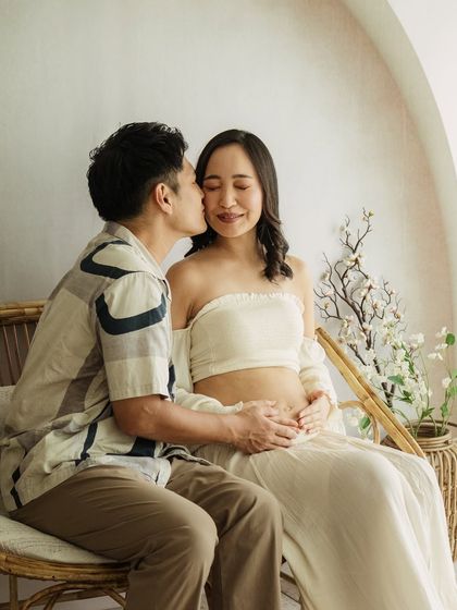 A sweet kiss on the cheek. I guide my clients into poses that feel natural and loving, capturing the genuine affection between them.