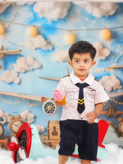 Our little pilot takes a break for an ice cream cone, a sweet and candid moment during the aviation-themed shoot.